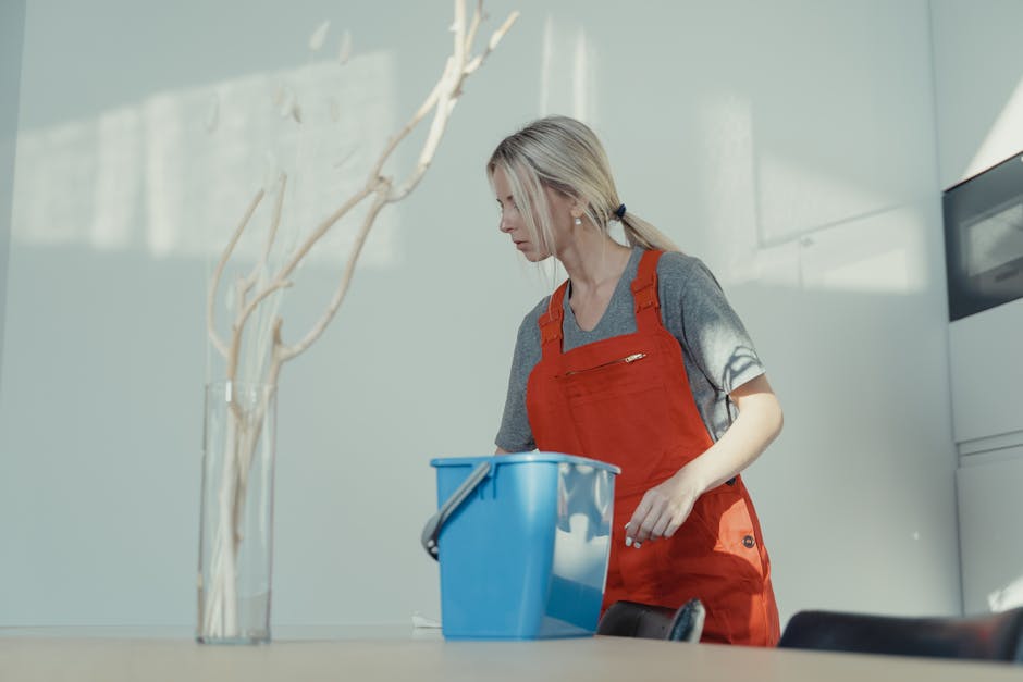 Smiling professional house cleaner in uniform