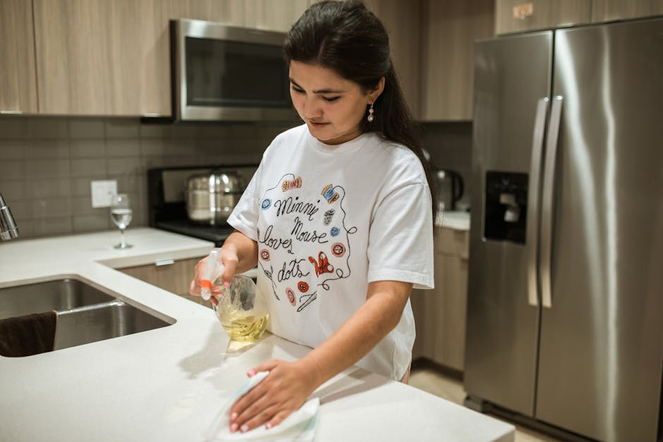 Professional wiping down a modern kitchen counter