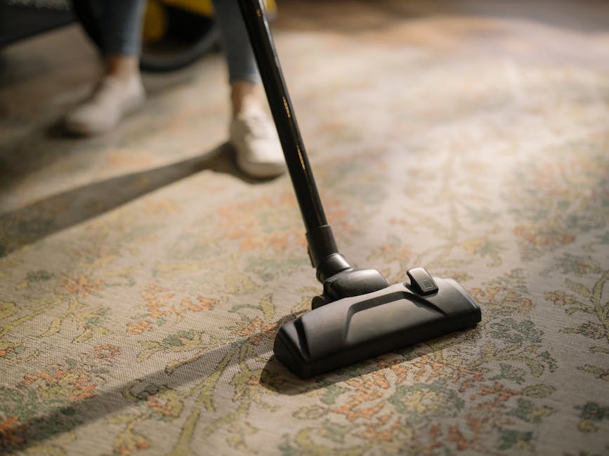 Maid vacuuming a residential carpet floor